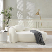 Sofa minimalista in tessuto Teddy beige con cuscino; design arrotondato