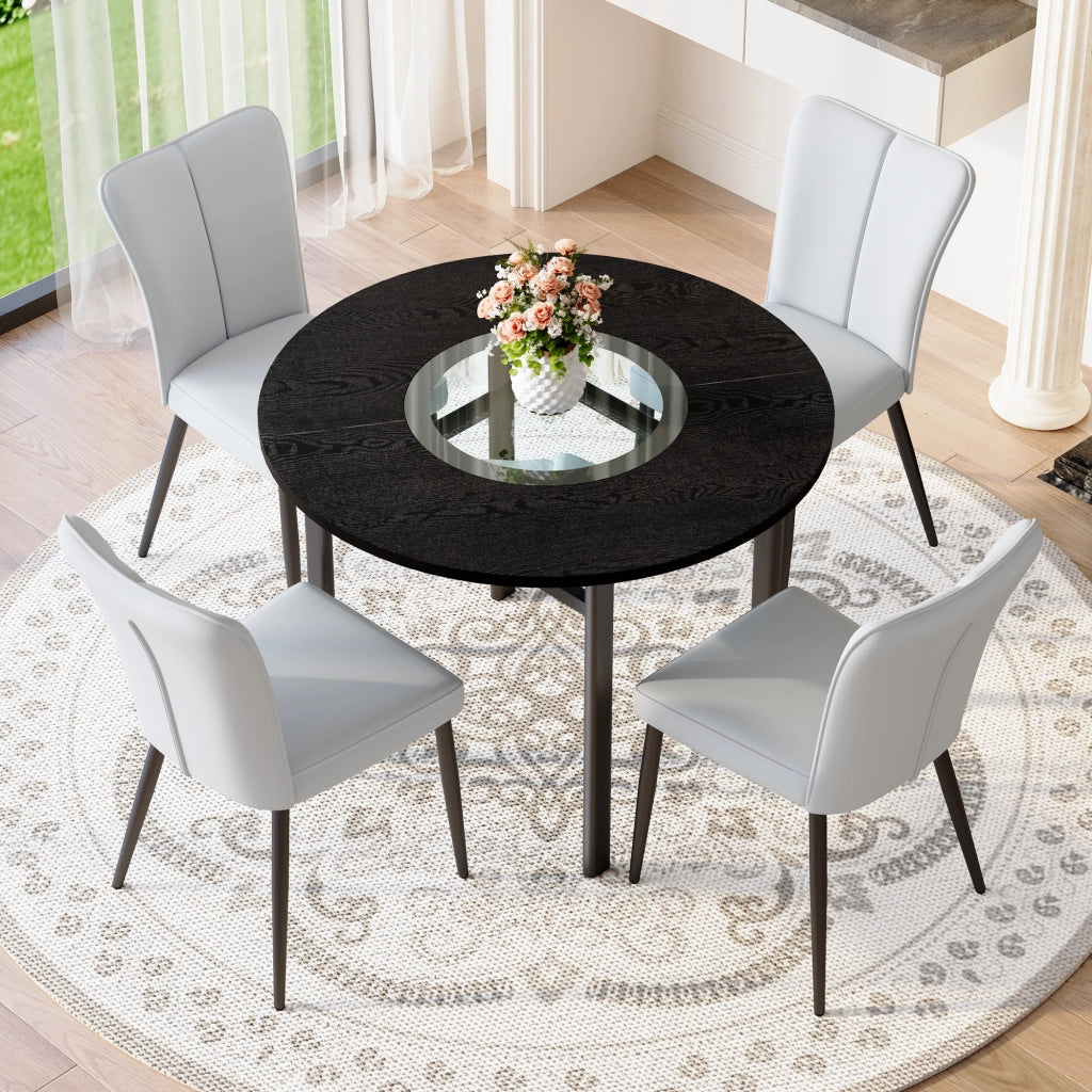 Tavolo da pranzo rotondo per 4 persone con piano in MDF effetto legno nero, inserto in vetro e 4 sedie grigie