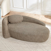 Divano minimalista in tessuto Teddy marrone con design arrotondato e cuscino di supporto