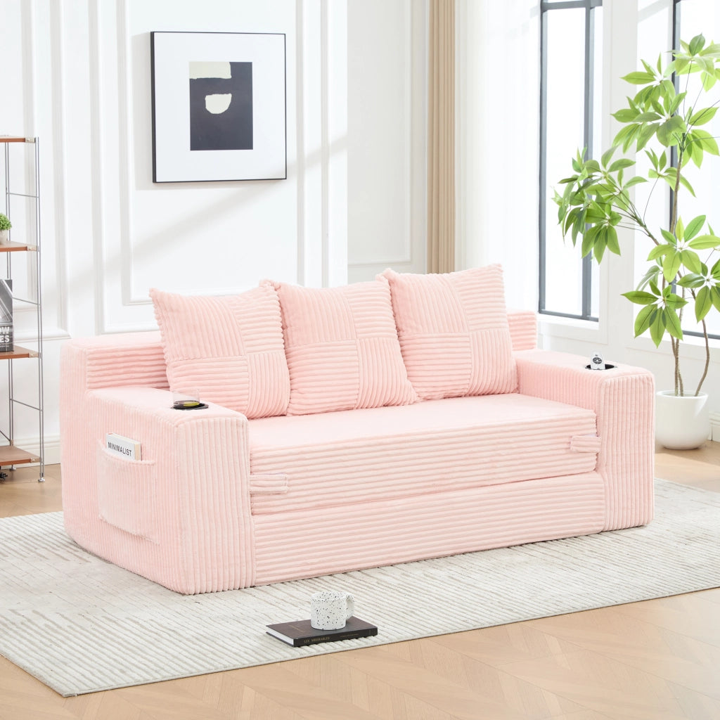 Divano tre posti in velluto a coste rosa; modulare salvaspazio con porta bicchieri