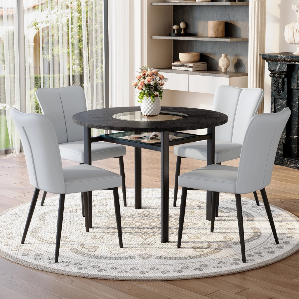 Tavolo da pranzo rotondo per 4 persone con piano in MDF effetto legno nero, inserto in vetro e 4 sedie grigie