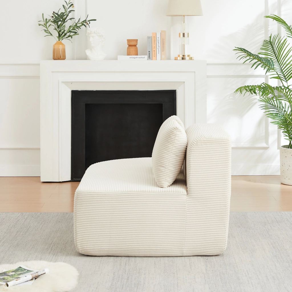 Divano angolare a L in velluto a coste beige con due moduli schienale e braccioli curvi con tre cuscini