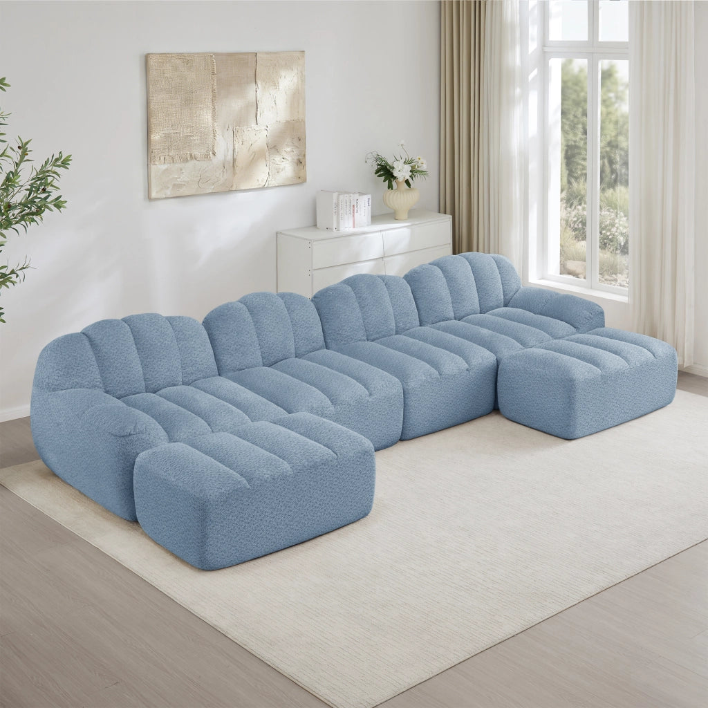 Divano angolare modulare a 4 posti con 2 pouf, seduta profonda e schienale ergonomico in tessuto blu per soggiorno