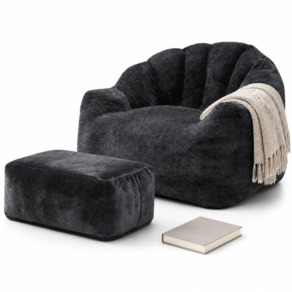 Poltrona relax con pouf abbinato in flannelette nera, design a petalo