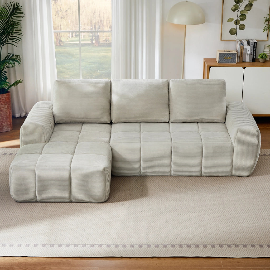 Divano angolare modulare con design segmentato e supporto in velluto a coste beige
