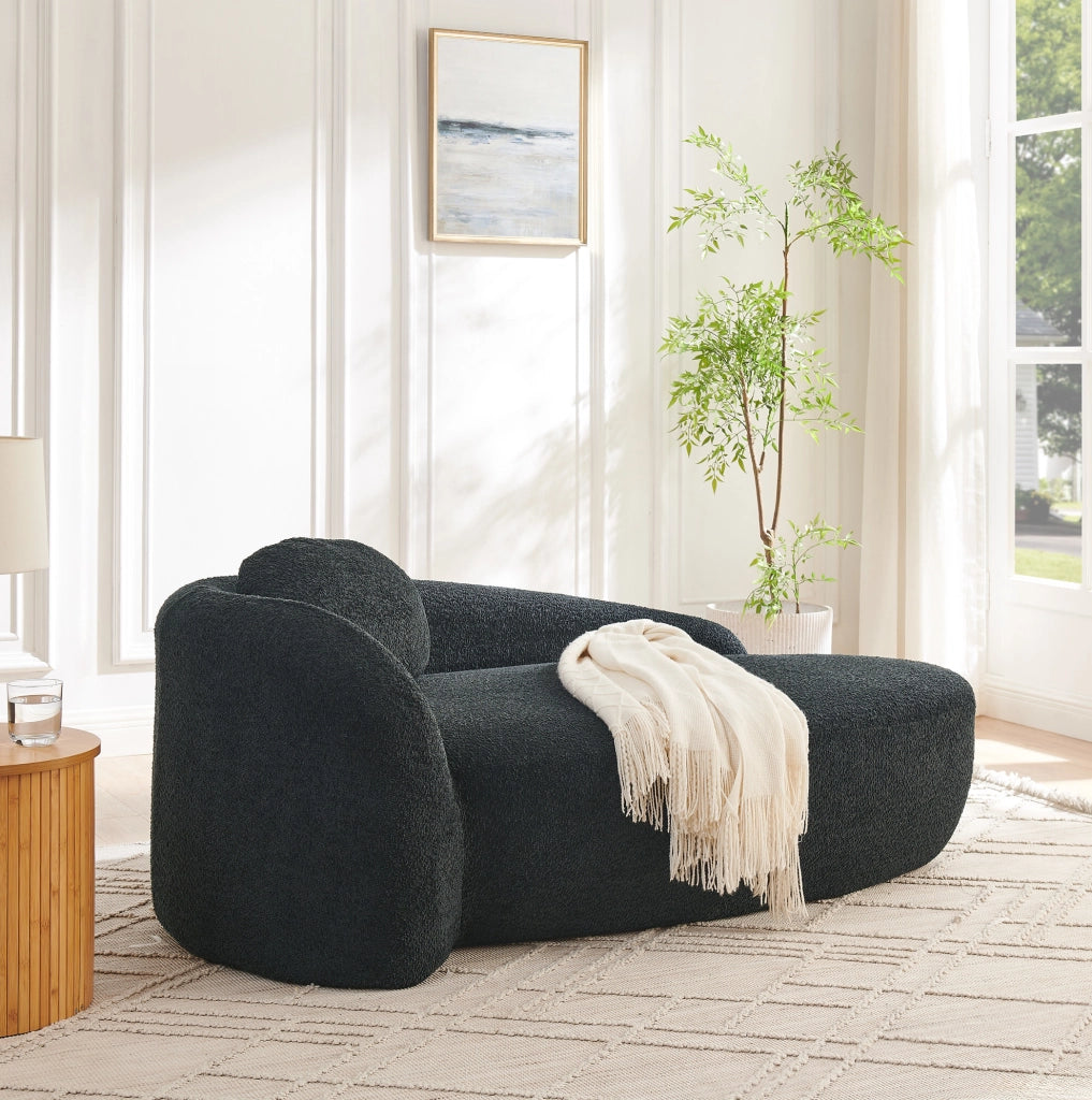 Divano minimalista in tessuto teddy nero con cuscino poggiatesta