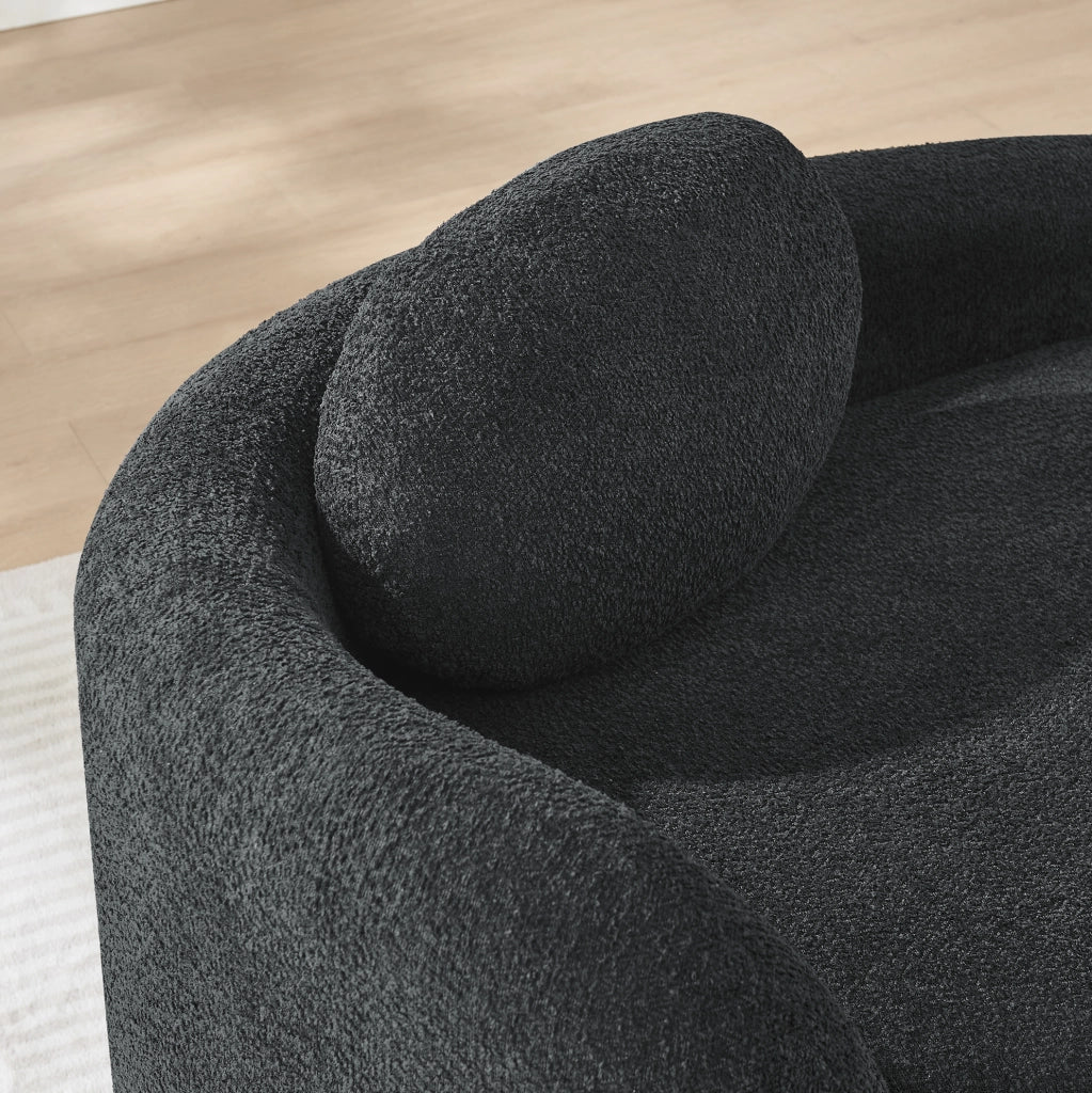 Divano minimalista in Teddy nero; morbido con cuscino testa; design arrotondato