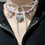 Collana con fiocco fatta a mano con perle rosa e viola.