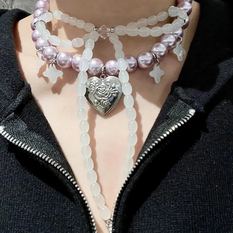 Collana con fiocco fatta a mano con perle rosa e viola.