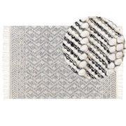 Tappeto in lana e cotone bianco e nero 160 x 230 cm, tessuto a mano a trama piatta con frange e motivo geometrico