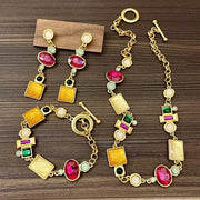 Set di collana, bracciale e orecchini realizzati a mano con pietre preziose artificiali colorate.