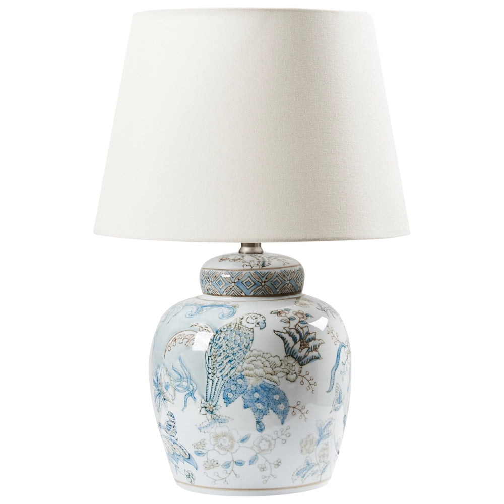 Lampada da tavolo con base in porcellana bianca e blu, paralume cilindrico in lino con un motivo