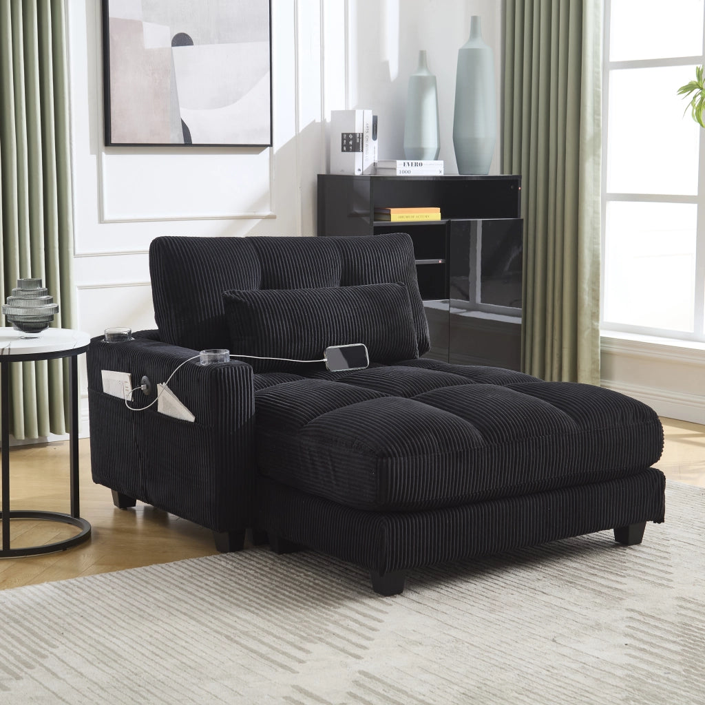 Poltrona lounge moderna in corduroy nero con porta bicchieri, tasche laterali e porte USB