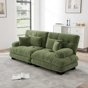 Divano modulare in ciniglia verde con braccioli arrotondati; cuscini lombari e decorativi