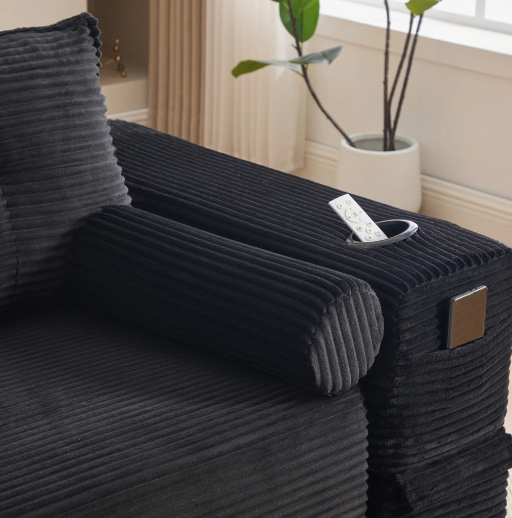 Divano letto ULEVR 232x98 cm in velluto a coste nero con portabevande, tasche laterali e cuscini memory