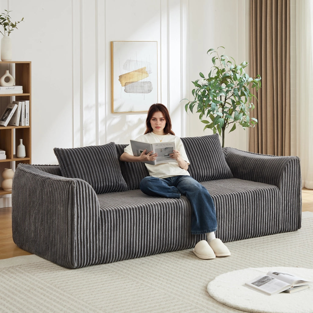 Divano modulare in corduroy con linee curve e schienale avvolgente, seduta ampia e due cuscini per soggiorno grigio