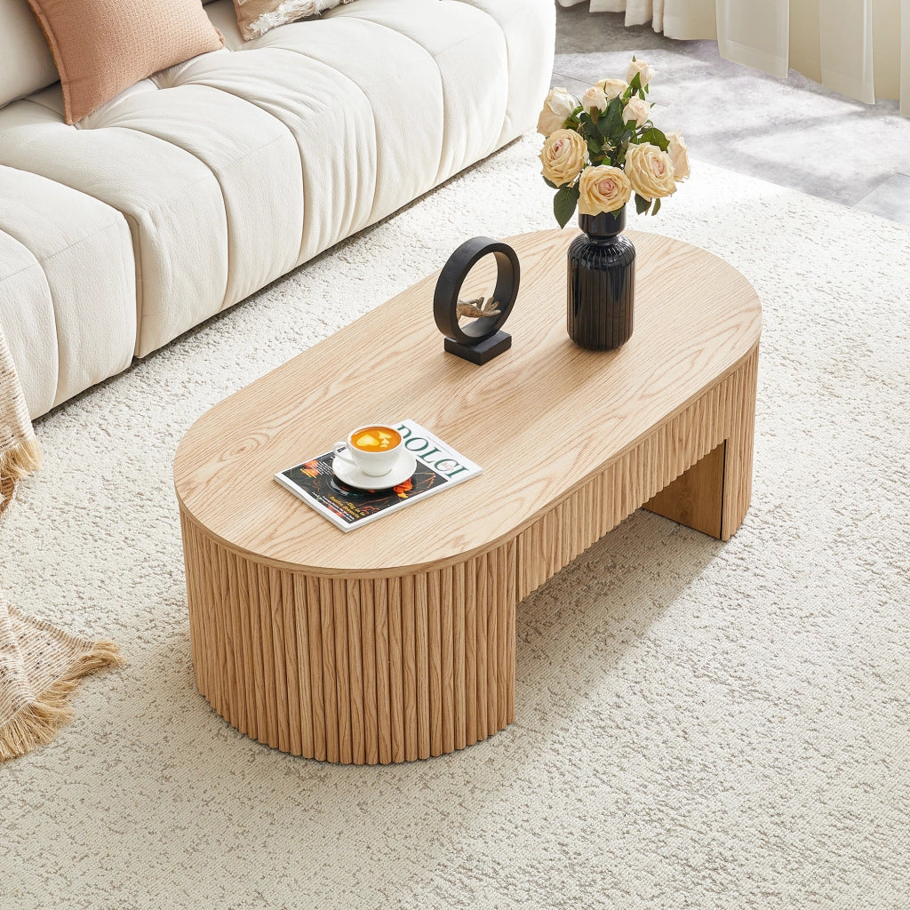 Tavolino basso ovale con cassetto e vano aperto frontali zigrinati in MDF effetto rovere chiaro per soggiorno 118 × 65 × 17 cm