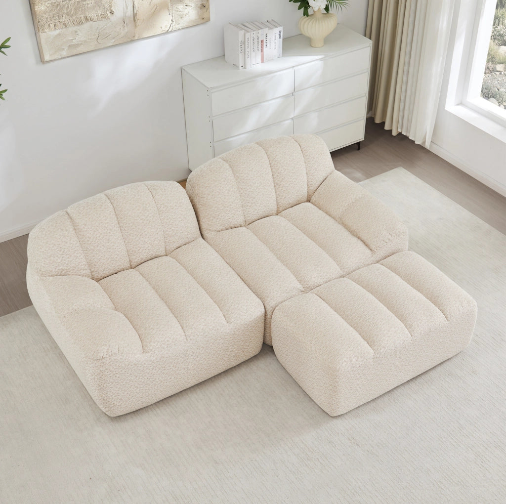 Divano modulare angolare 210.0x165.0x79.0 cm con ottoman senza montaggio in pile granulato beige e bianco