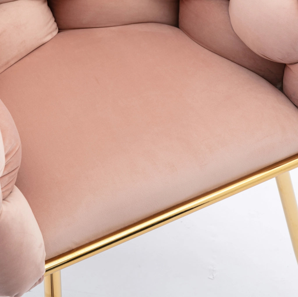 Poltrona con braccioli imbottita in velluto e metallo rosa