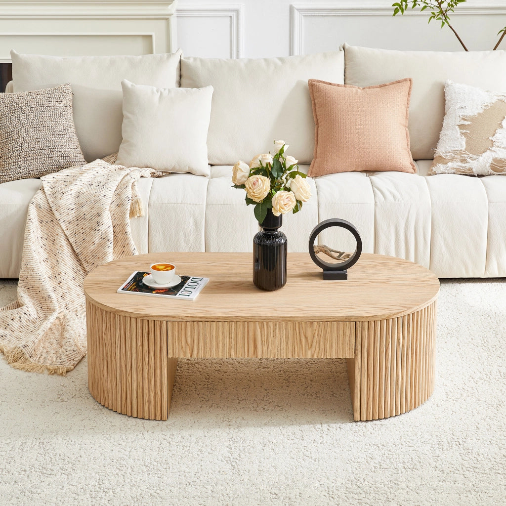 Tavolino basso ovale con cassetto e vano aperto frontali zigrinati in MDF effetto rovere chiaro per soggiorno 118 × 65 × 17 cm