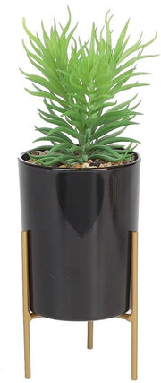 Pianta finta con foglie verdi su base in ceramica nera per decorazione di interni, estetica e arredamento di casa, ufficio o bagno.