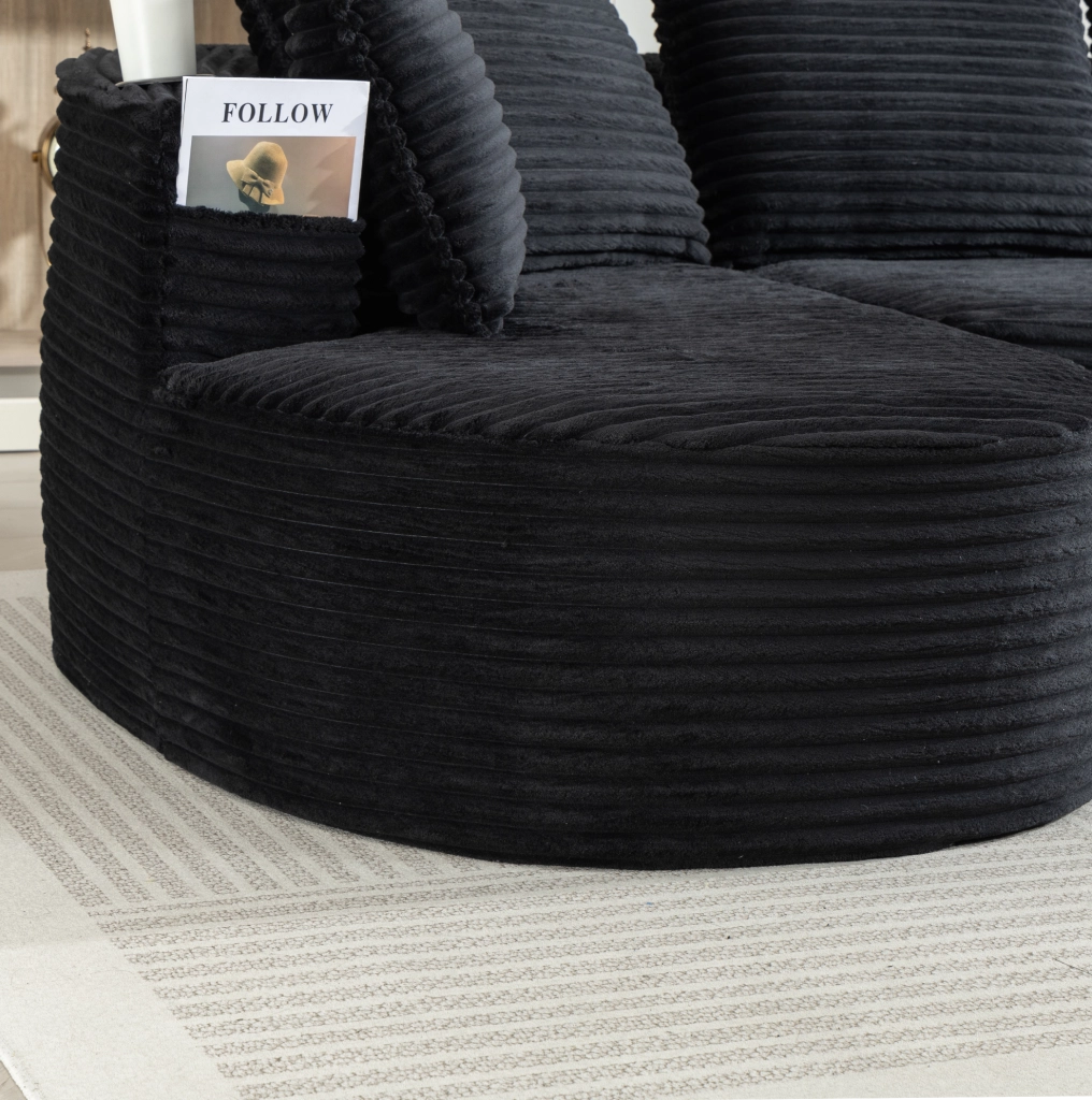 Divano ad arco nero in velluto a coste con portabevande e tasche laterali per il massimo relax