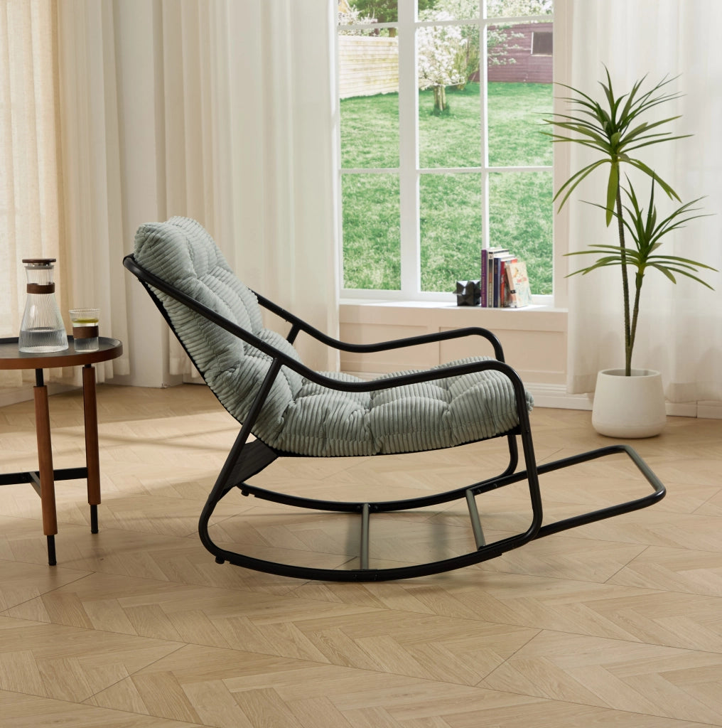 Poltrona a dondolo con pouf, struttura nera e cuscino verde chiaro