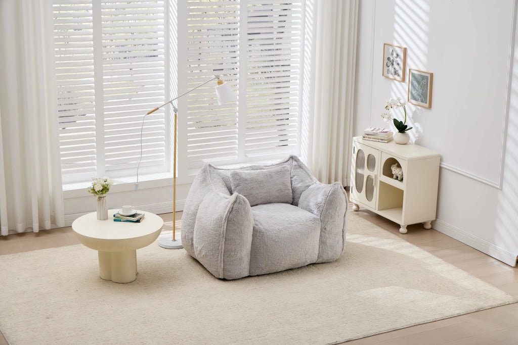 Poltrona pouf con schienale ergonomico e imbottitura in schiuma, in pelliccia sintetica grigia per soggiorno