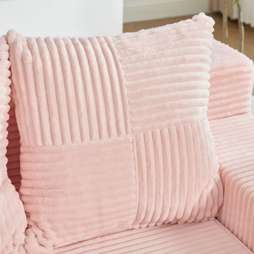 Divano pouf in velluto a coste rosa con due cuscini tasche laterali e braccioli