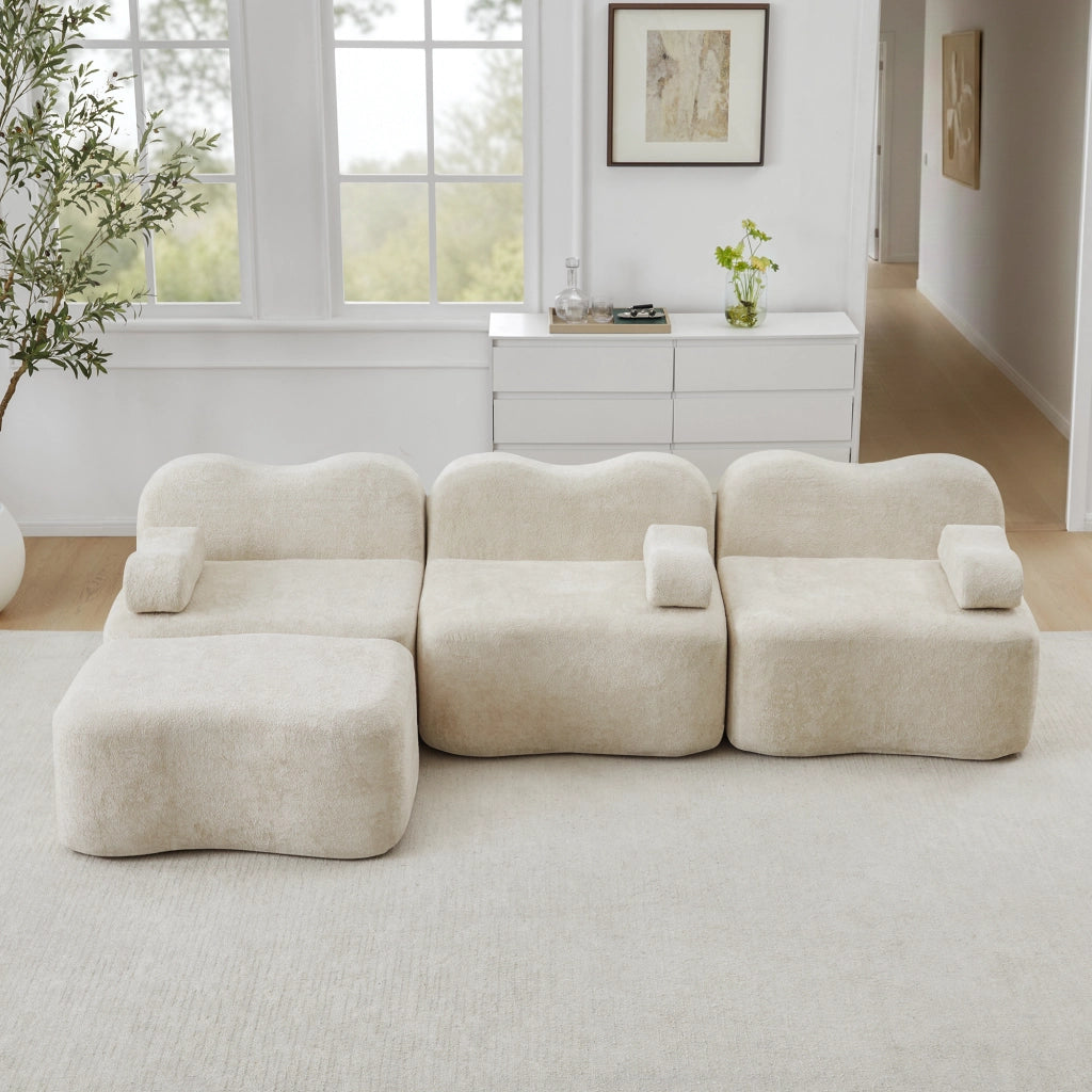 Divano angolare modulare senza struttura con seduta profonda e pouf collegabile in velluto beige per soggiorno