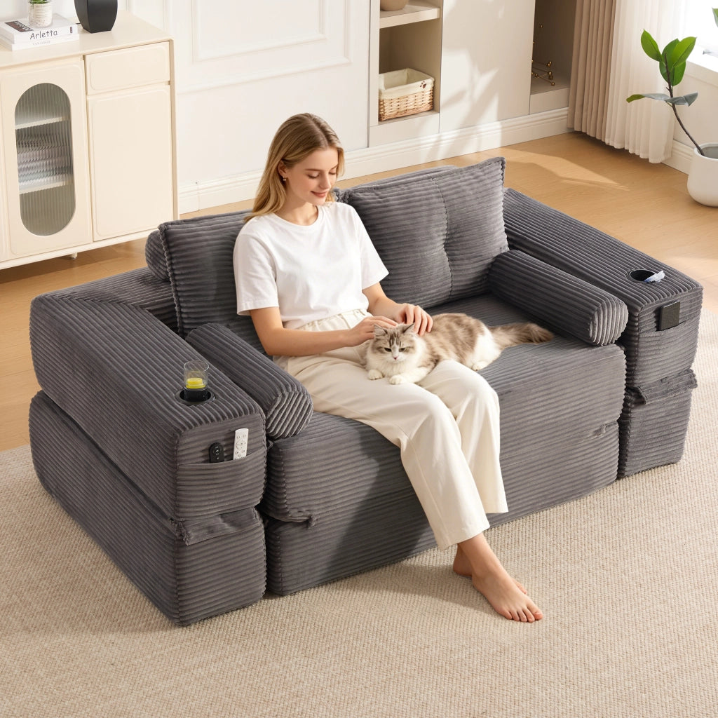 Divano letto modulare in tessuto a coste con tasche laterali, portabicchieri e cuscini memory grigio scuro