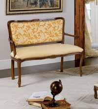 Divanetto imbottito in legno massello intagliato con fregi