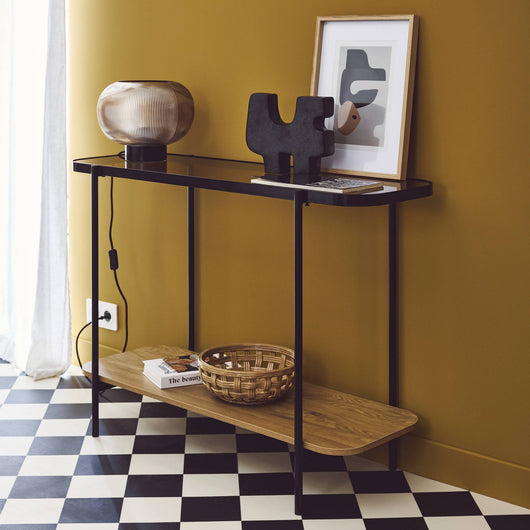 Consolle vintage in metallo nero con piano in vetro e decori in legno,