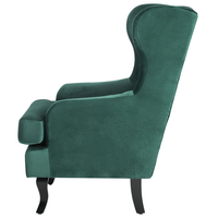 Sedia Wingback con rivestimento in velluto verde e gambe nere in stile scandinavo