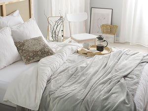 Coperta grigio chiaro copriletto 150 x 200 con pon pon morbido copriletto