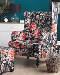 Poltrona con poggiapiedi in tessuto Nero motivo floreale gambe in legno stile Wingback