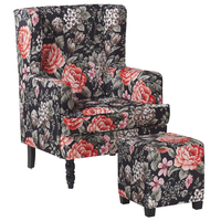 Poltrona con poggiapiedi in tessuto Nero motivo floreale gambe in legno stile Wingback