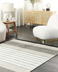 Tappeto beige e nero lana cotone 160 x 230 cm rettangolare intrecciato a mano con frange