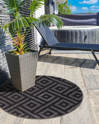 Tappeto rotondo per interni e per esterni con motivo geometrico ⌀ 120 cm nero e grigio stile moderno balcone patio